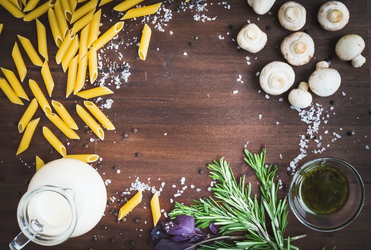 Mushroom pasta ingredients: penne, mushrooms, a jug of cream, pe